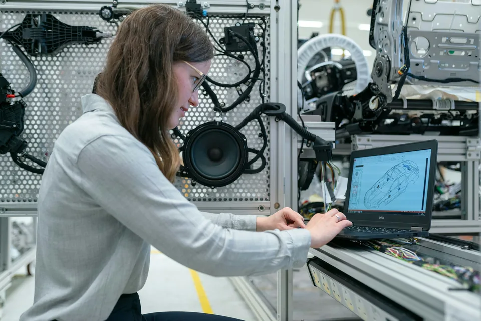 An electronics engineer conducting vehicle tests on a laboratory test bench